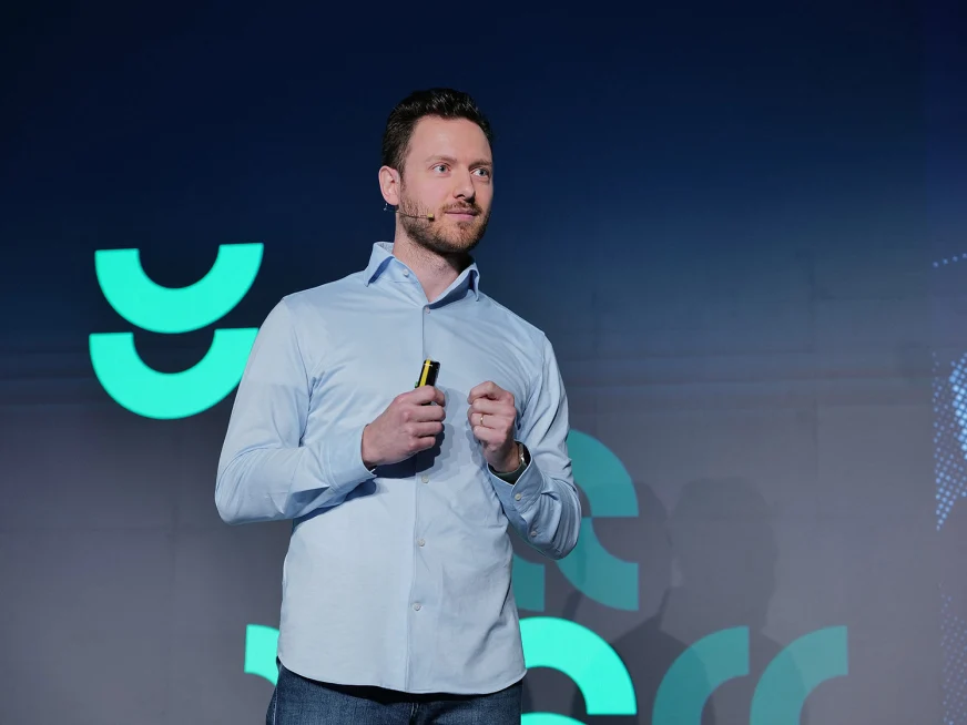 Adyen team member in a light blue shirt prepares to present or demonstrate in the Adyen office.