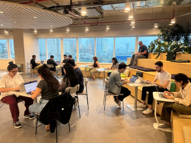Adyen team members working together in a modern office space with city views