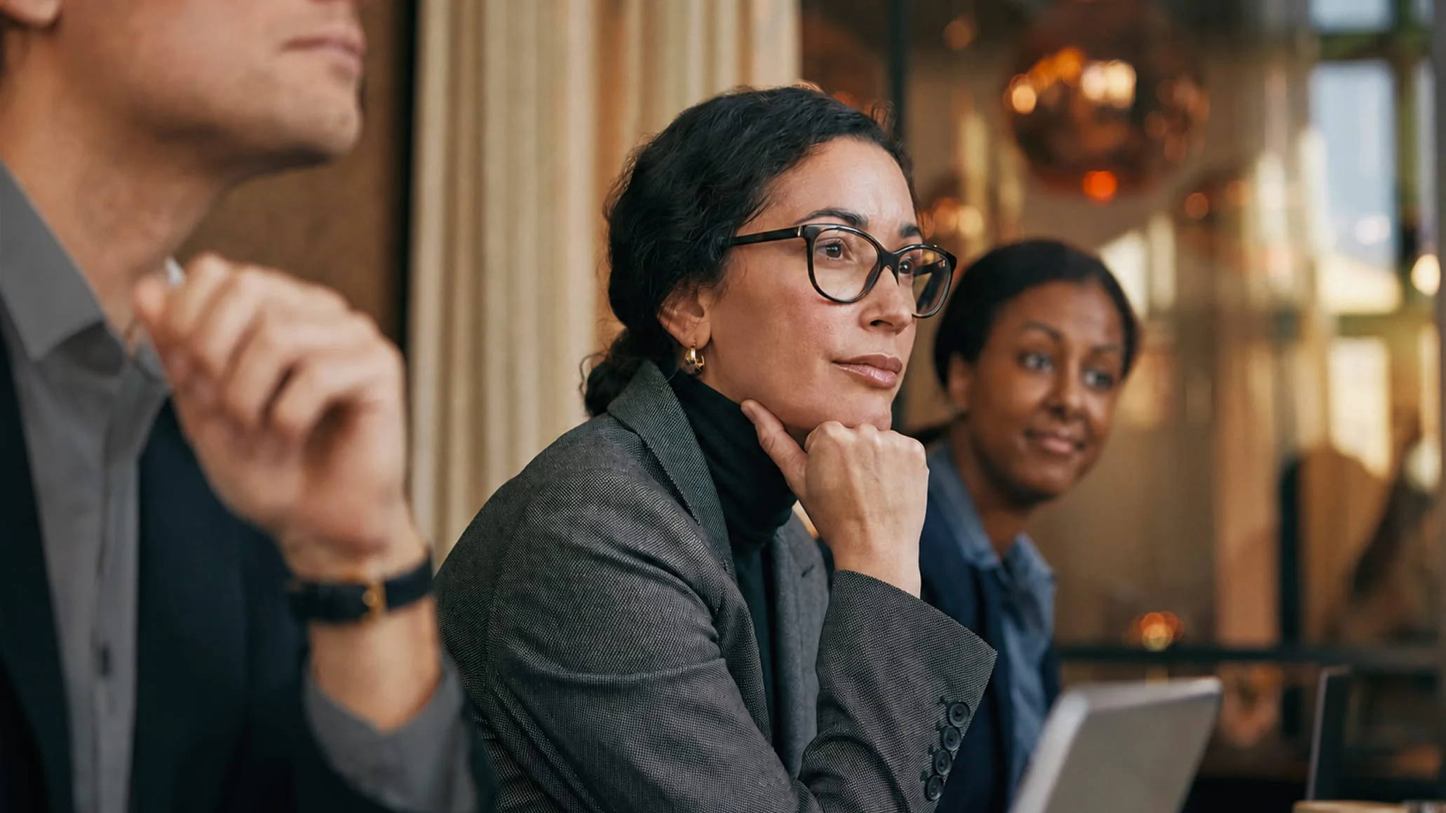 Adyen team members in a meeting, with a payment terminal visible on the table during a business discussion.