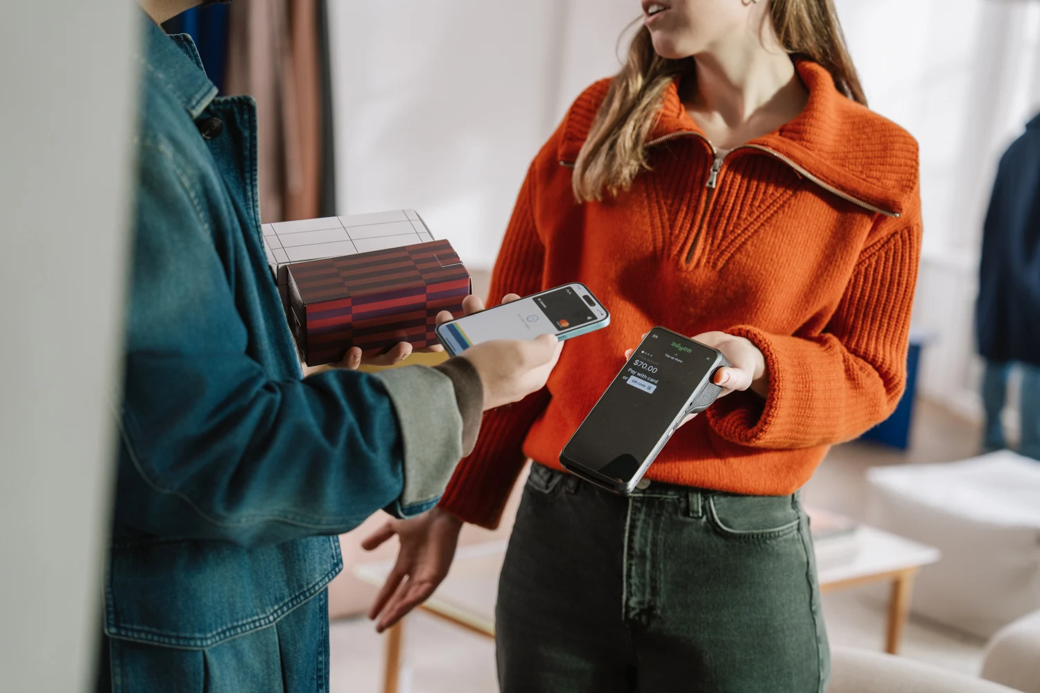 A customer and an Adyen team member completing a contactless payment transaction.