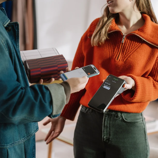 A customer and an Adyen team member completing a contactless payment transaction.