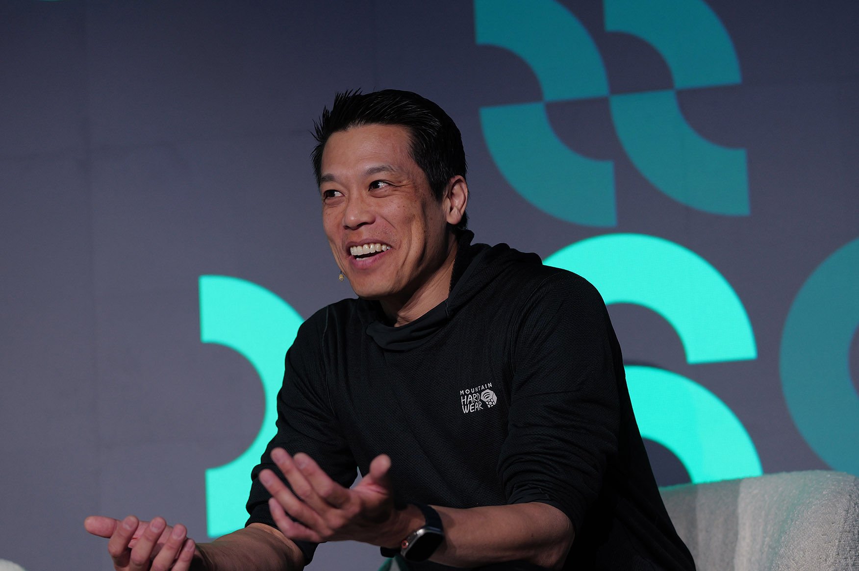 Adyen employee speaking during a presentation or panel discussion in the Adyen office.