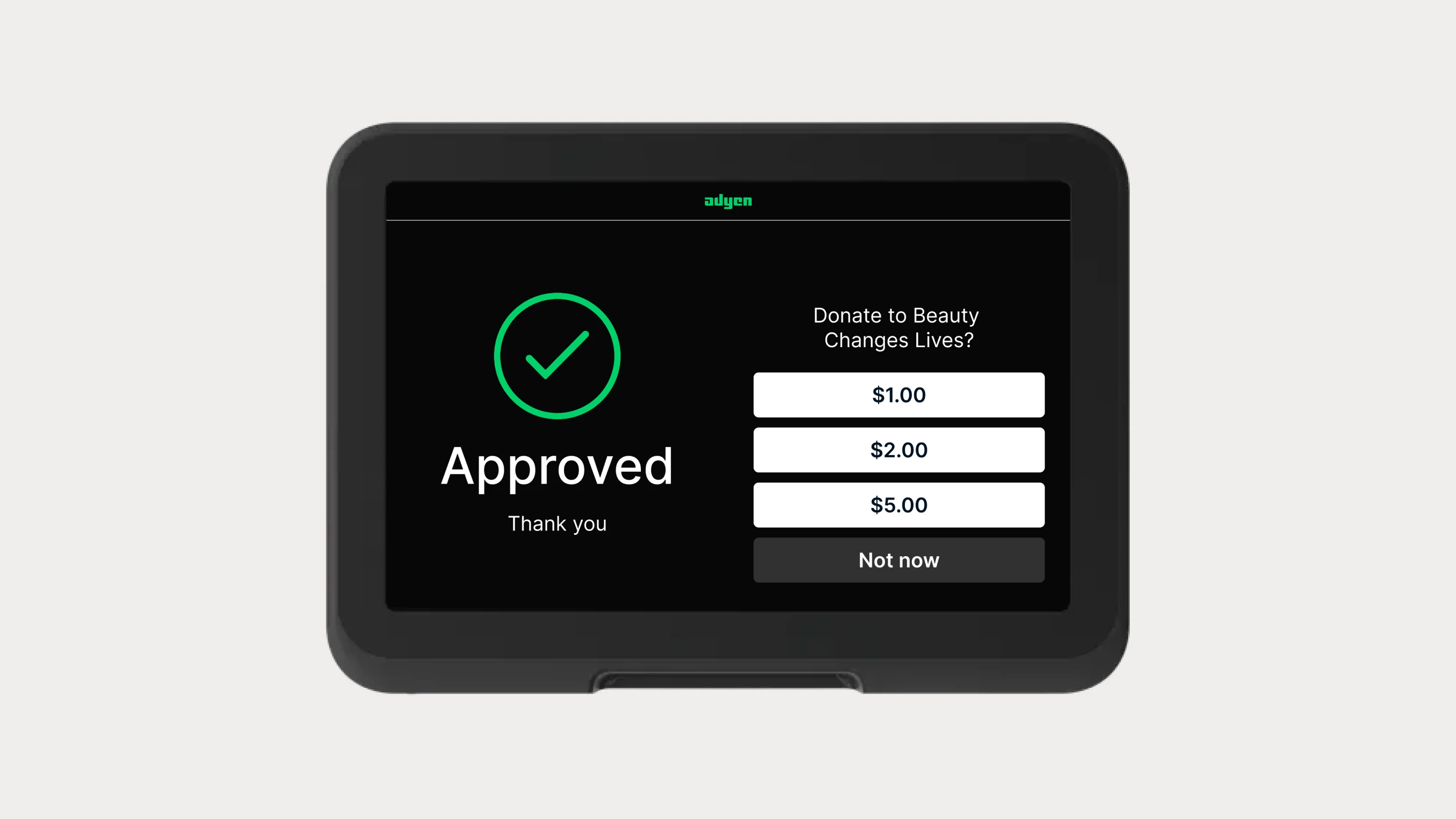 Digital payment terminal displaying a successful donation approval screen by Adyen