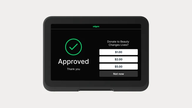 Digital payment terminal displaying a successful donation approval screen by Adyen