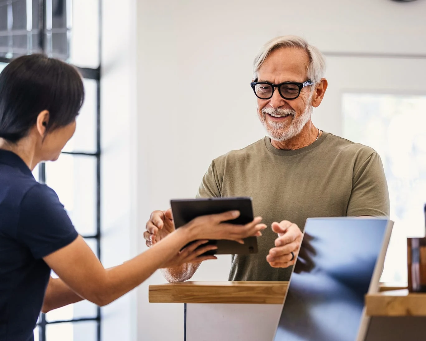 Adyen employees in the Adyen office sharing a payment transaction using an Adyen terminal.