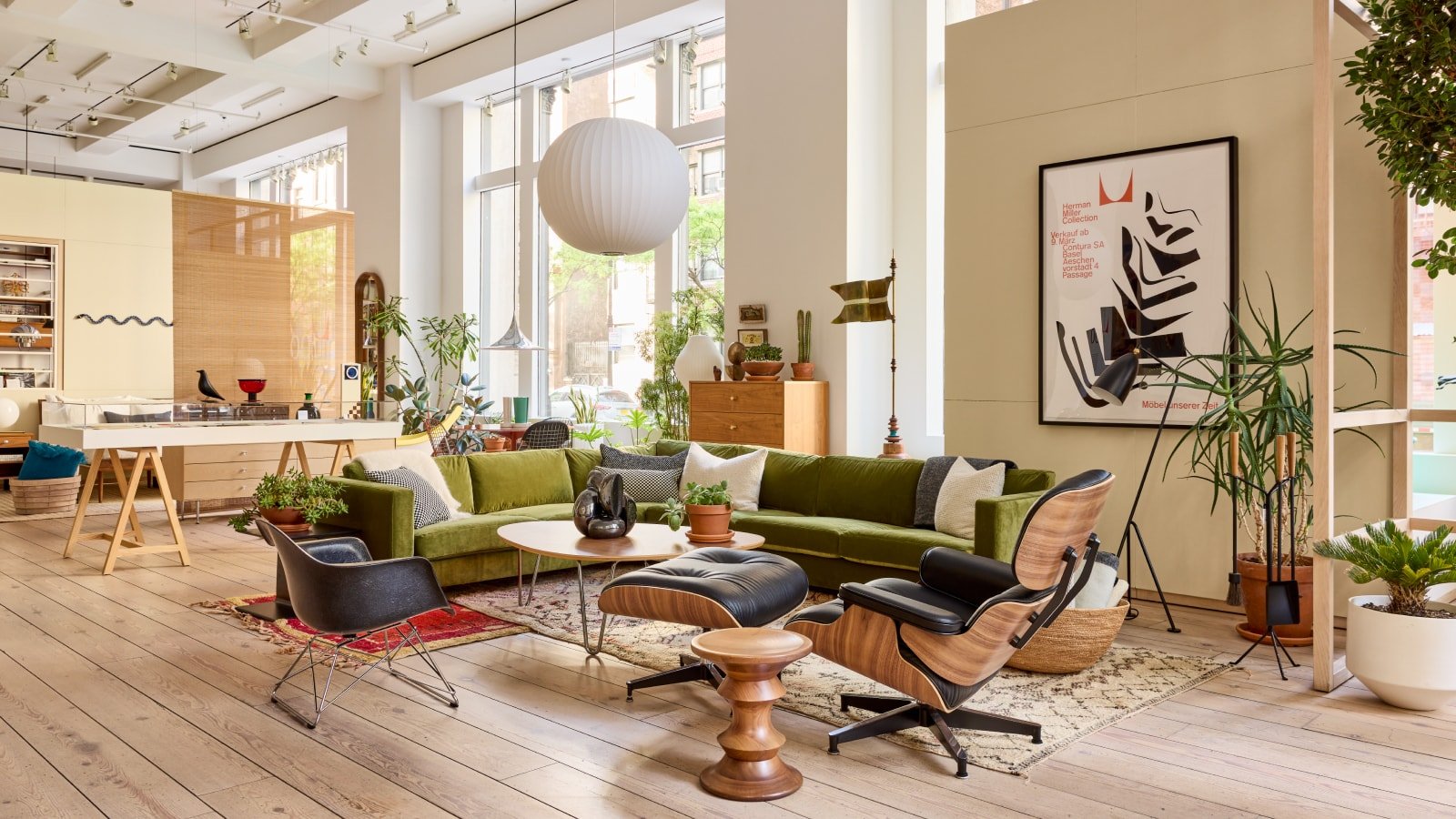 Stylish lounge with seating, plants, and artwork in a bright modern interior of an Adyen office space