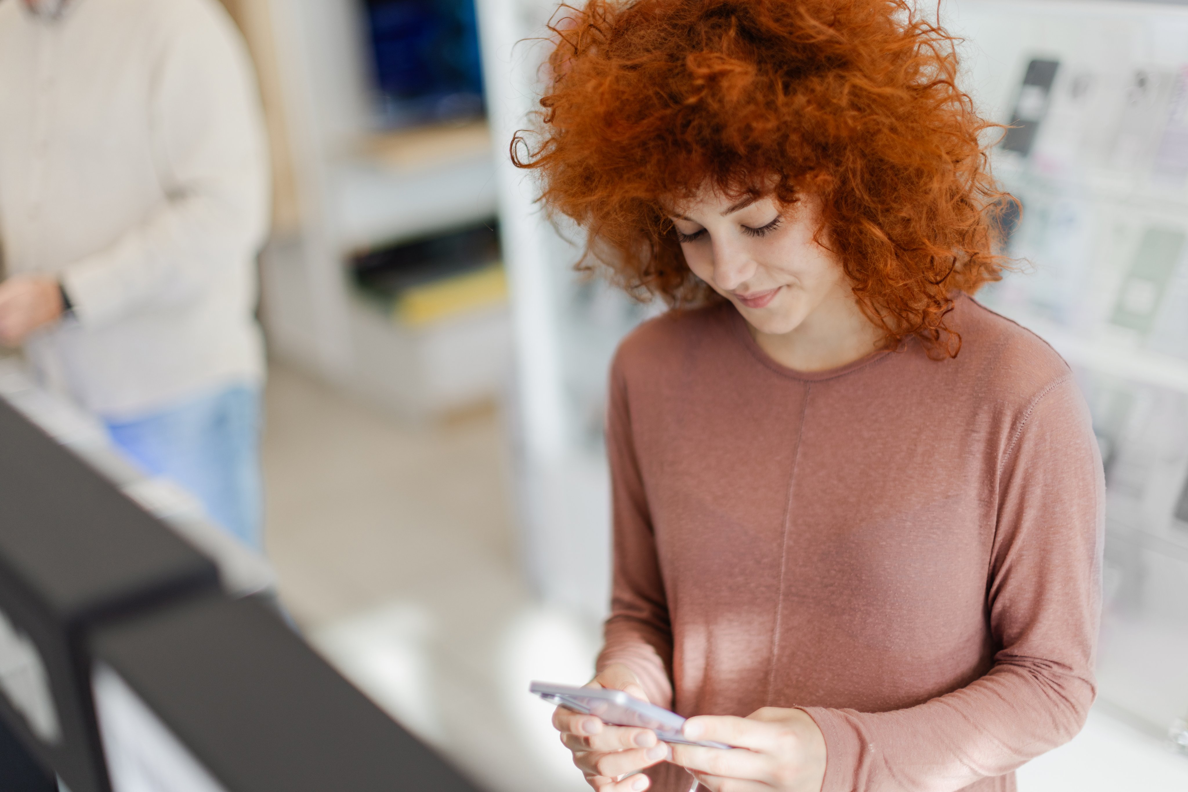 Adyen team member using a smartphone in the office setting