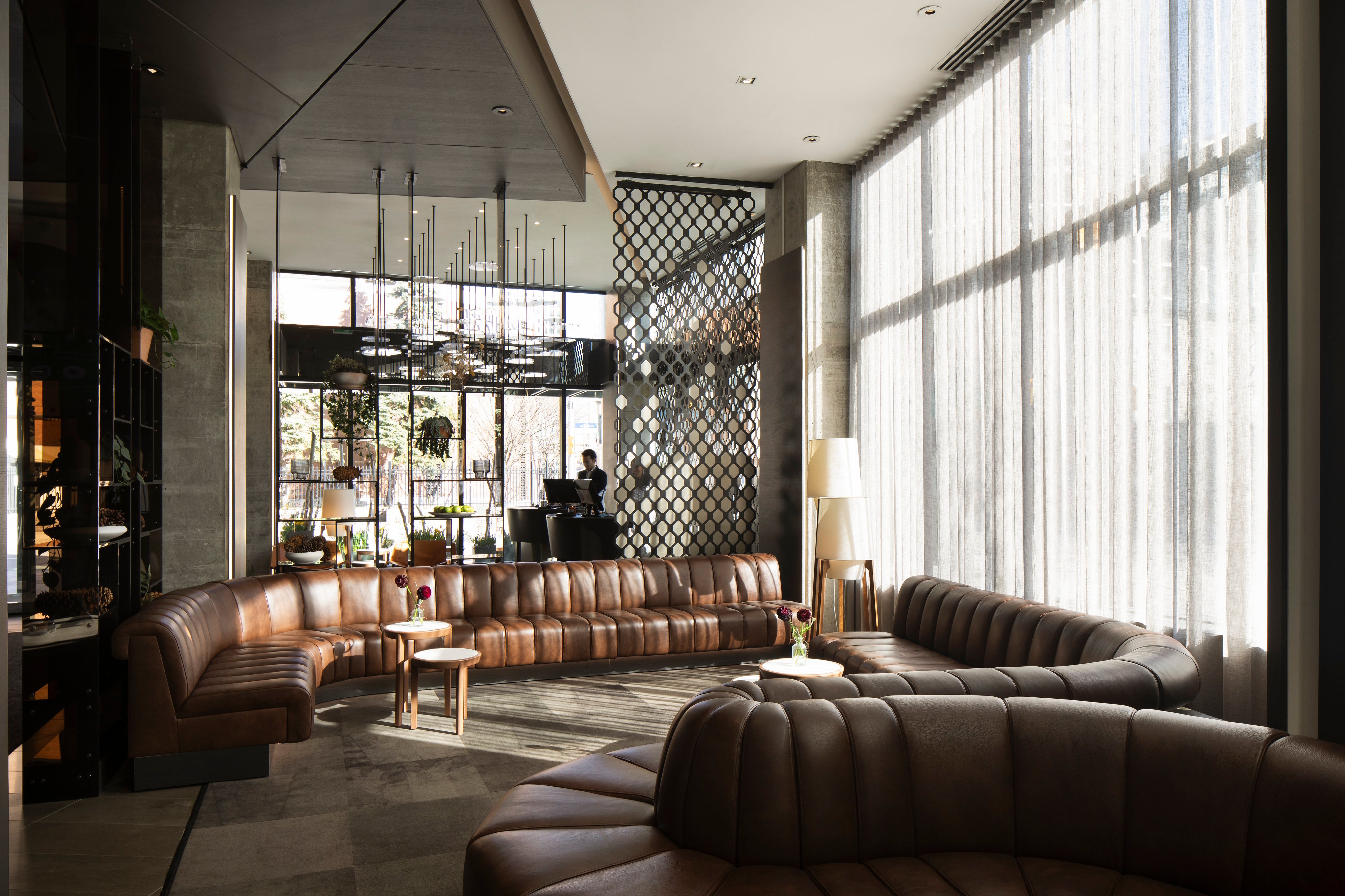 Modern lounge area with plush seating and large windows in an Adyen office environment