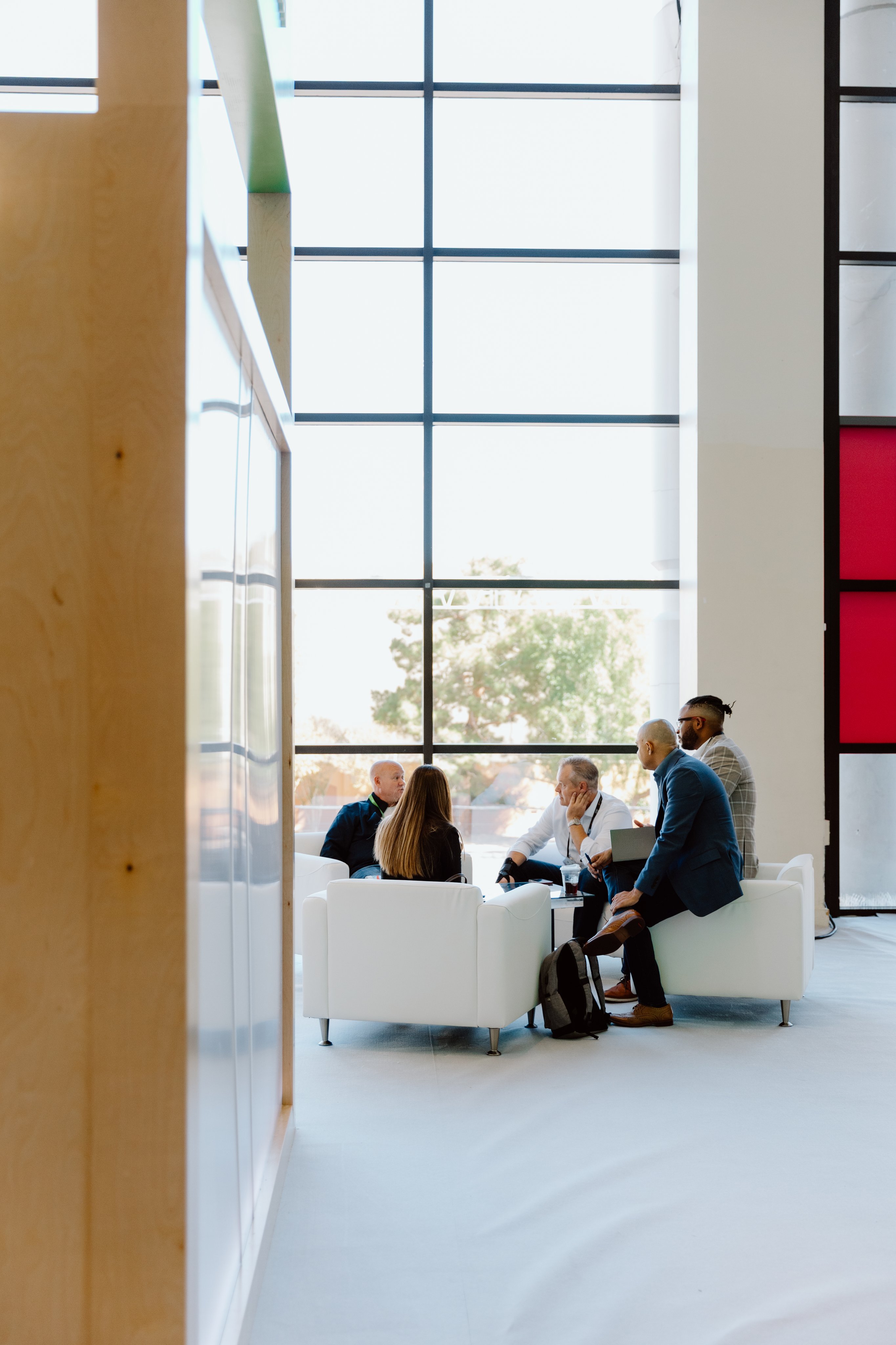 Adyen employees in the office engaging in a discussion, with payment activity provided by an Adyen terminal visible.