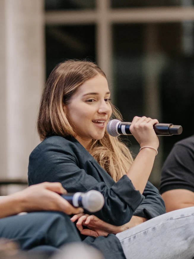 Woman speaking into a mic
