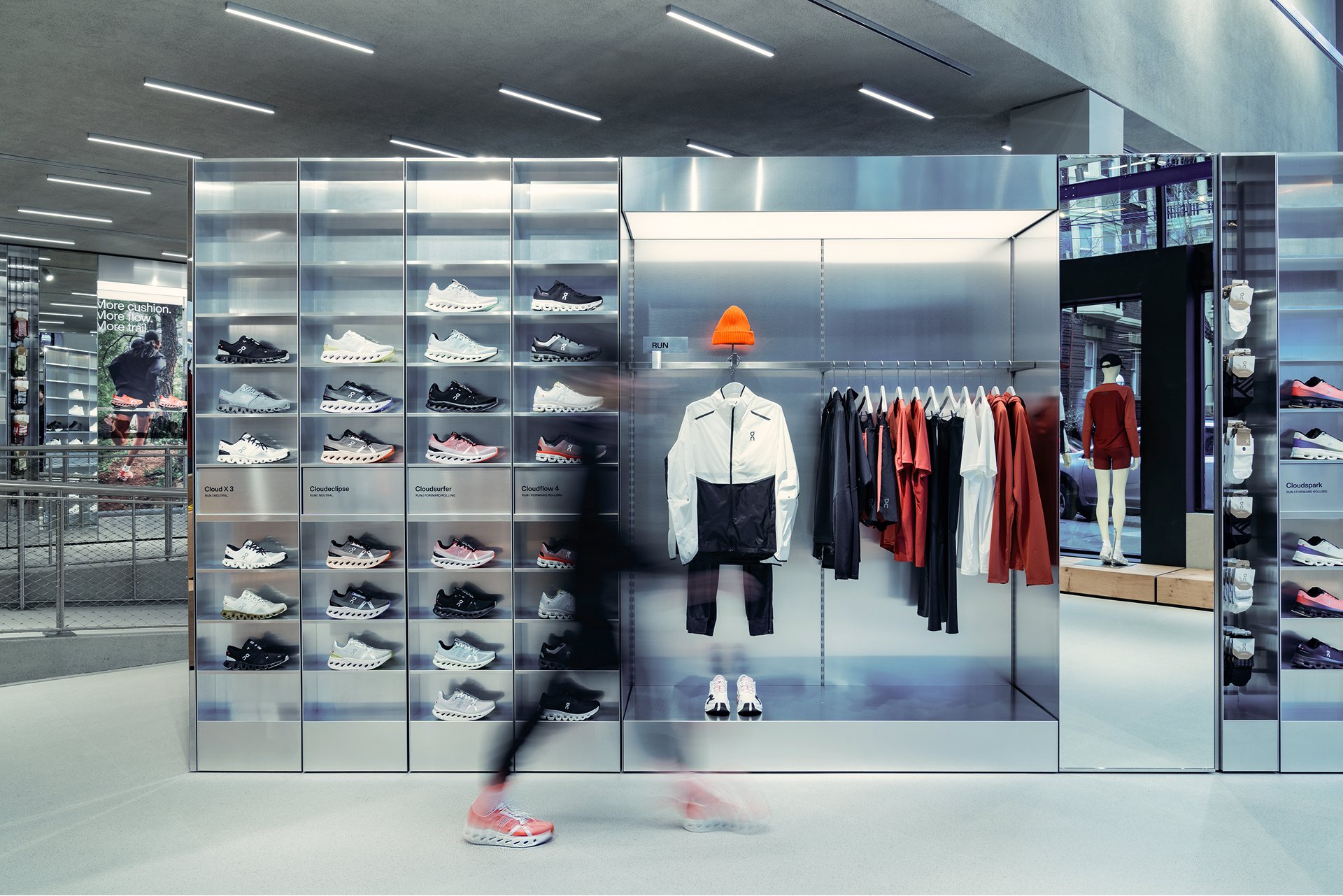 A retail display with shoes and clothing in a modern store interior.