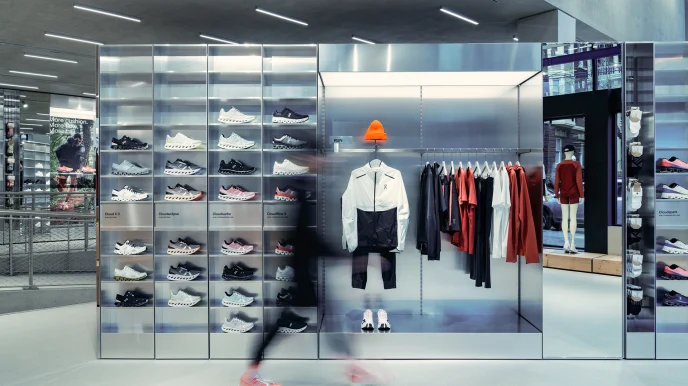 A retail display with shoes and clothing in a modern store interior.