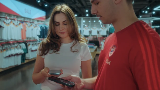 A customer using a payment terminal provided by Adyen during a retail checkout.