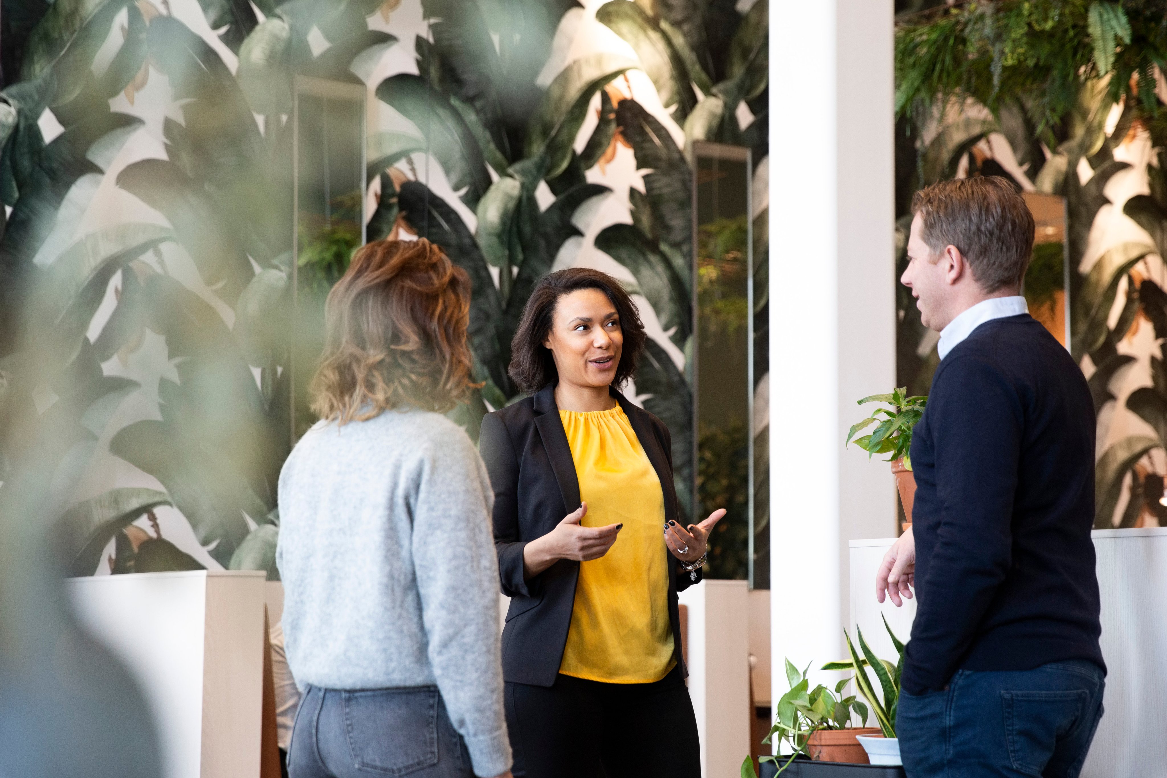 Adyen employees in the Adyen office discussing a payment transaction with a customer.