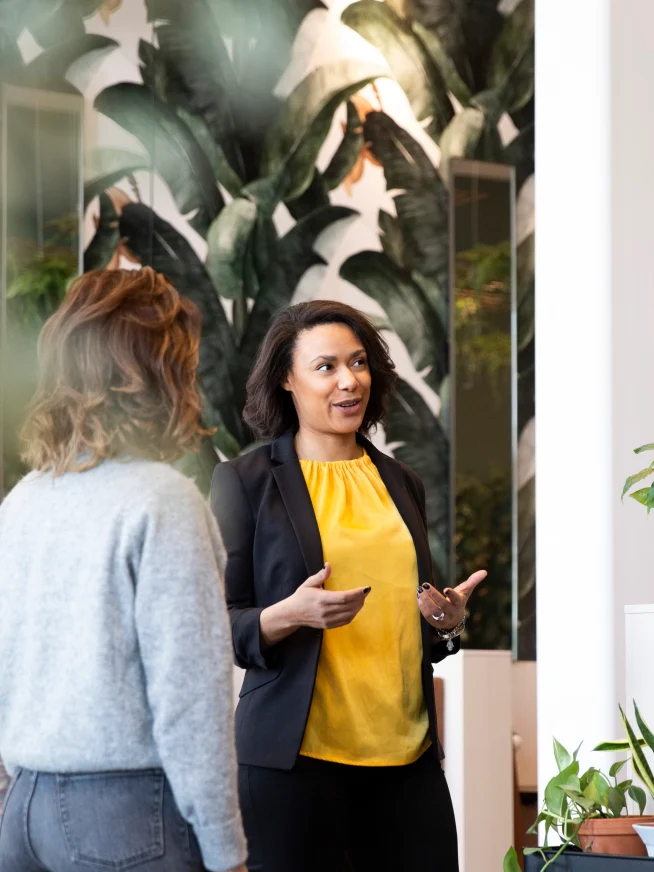 Adyen employees in the Adyen office discussing a payment transaction with a customer.