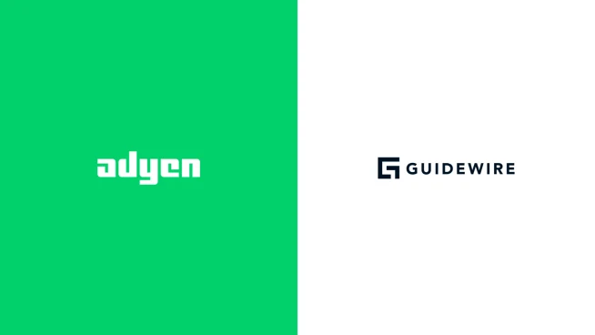 Adyen employees in the Adyen office displaying logos of Adyen and Guidewire on a presentation wall.