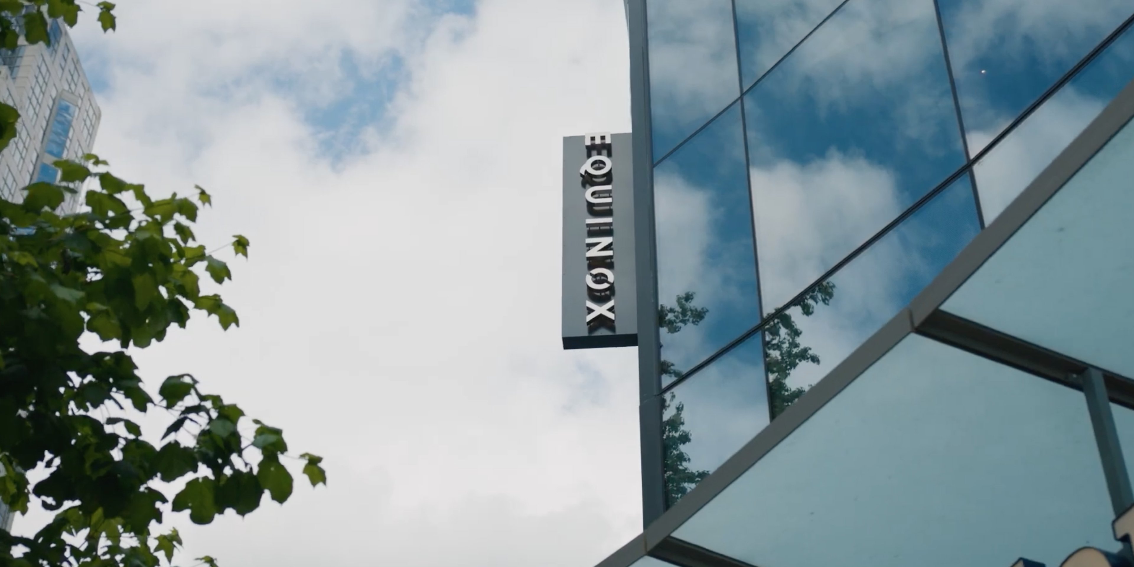 Close-up of the exterior entrance of an Equinox gym with the brand logo displayed.