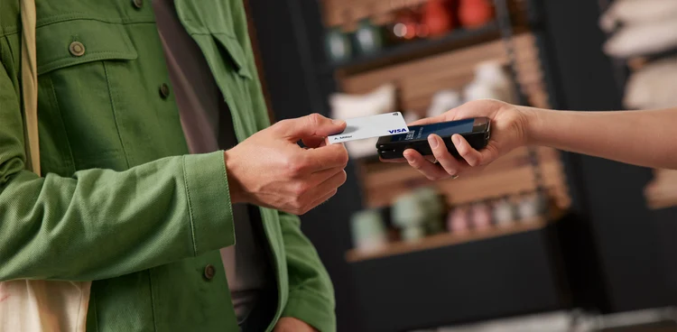 A customer making a payment using an Adyen terminal at a retail store