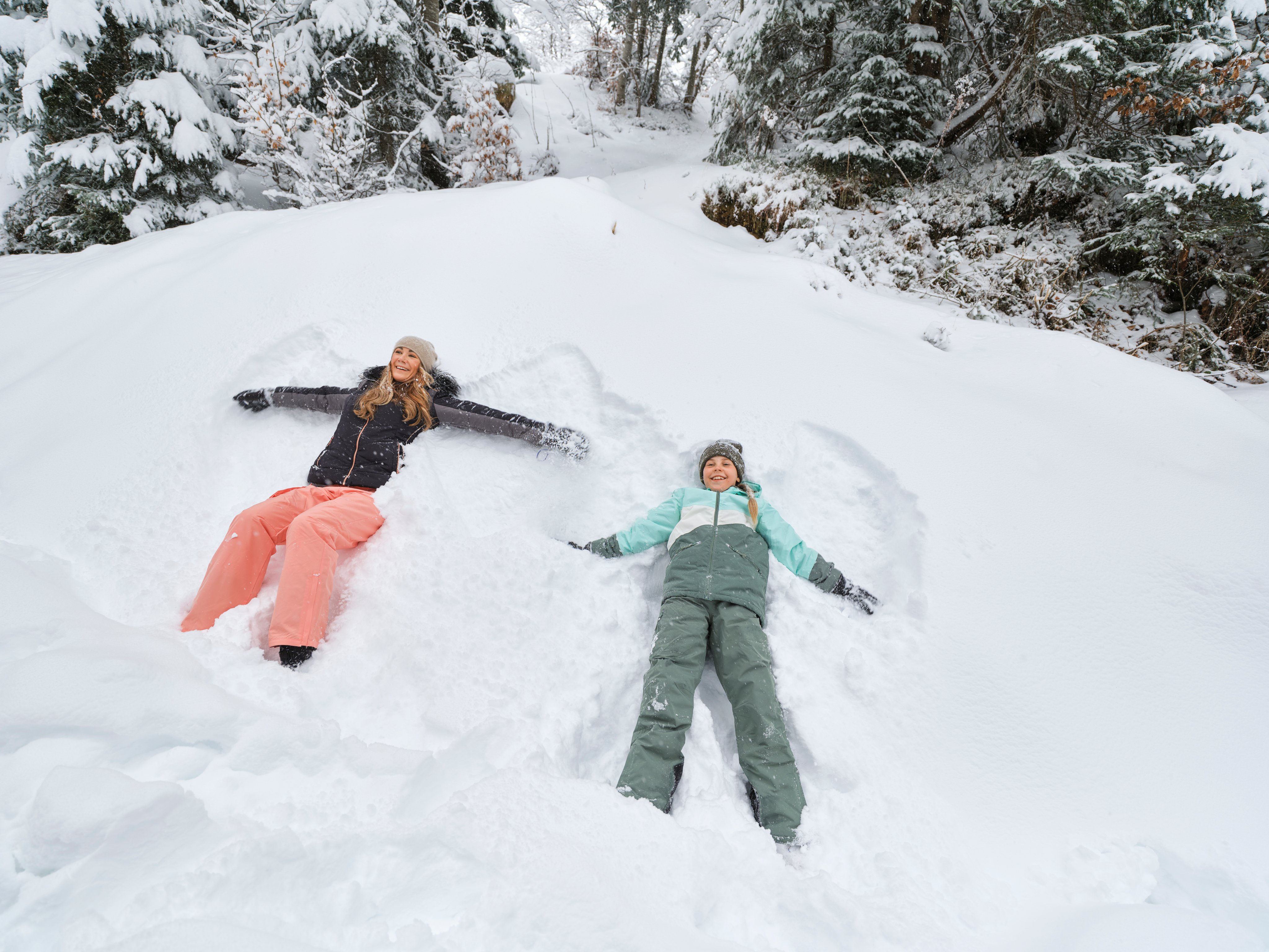 Zwei Kinder machen Schneemann im verschneiten Wald bei Aldiana Snow Winter Urlaub