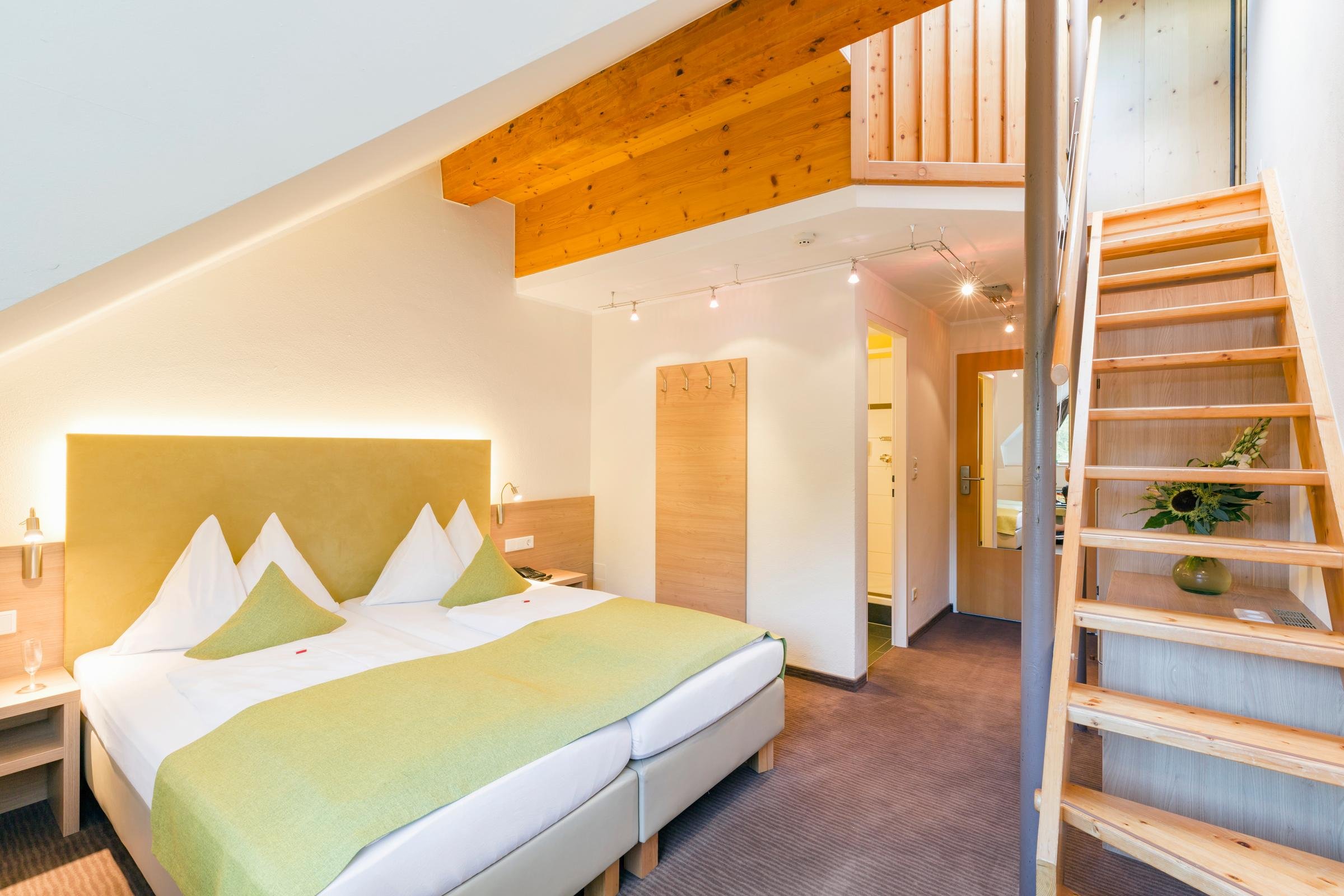 Elegantes Hotelzimmer bei Aldiana mit Doppelbett, Holzdecke und modernem Design