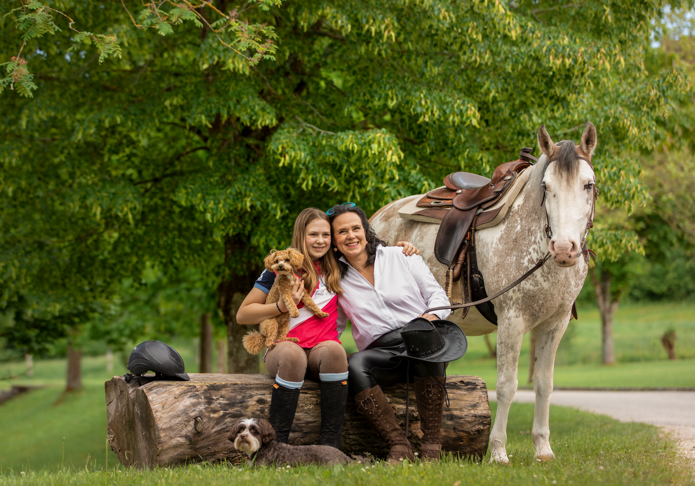 Frau mit Pferd und kleinem Hund auf Bank im Grünen bei Aldiana Premium Cluburlaub
