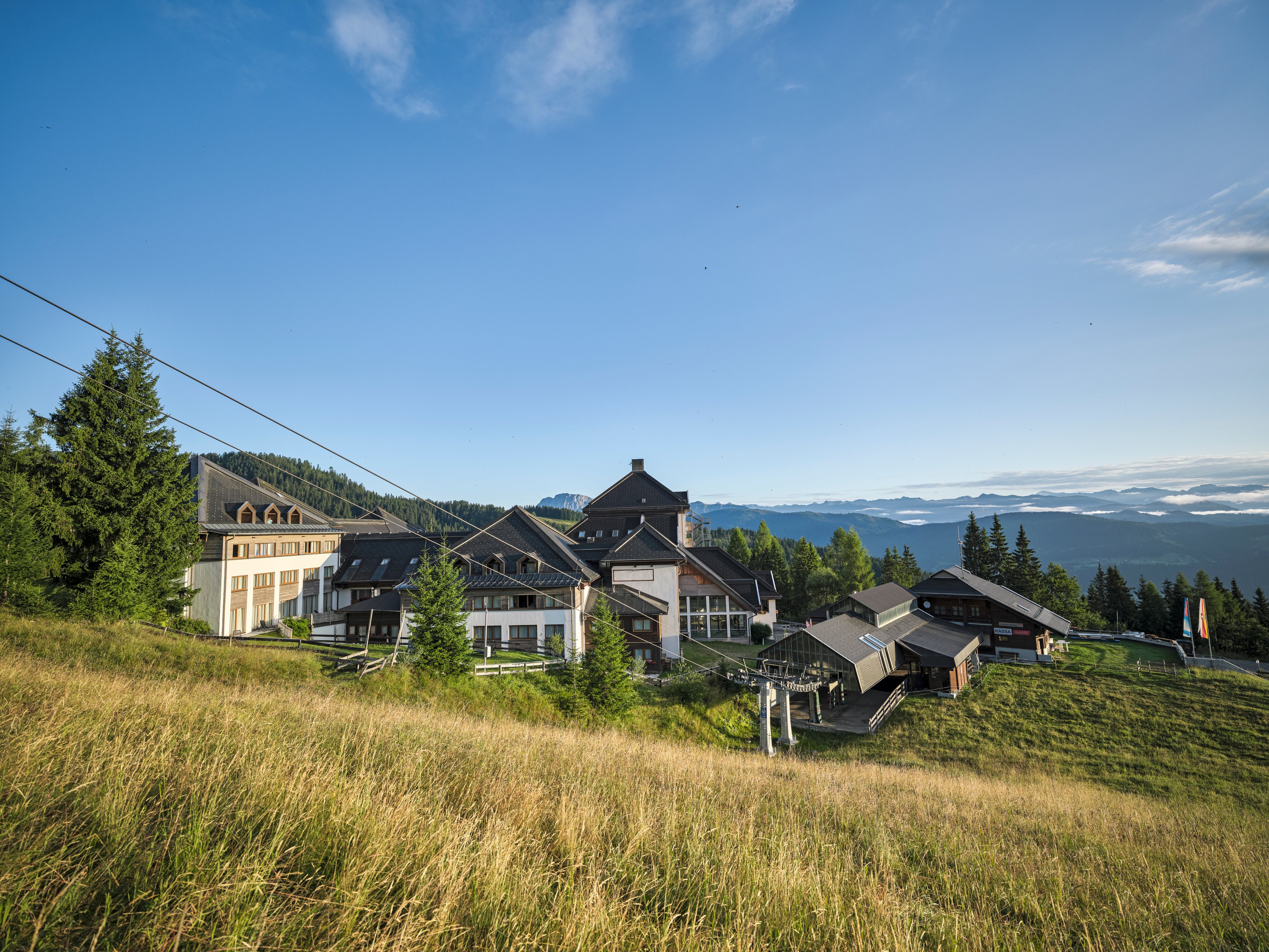 Bild einer eleganten Aldiana Clubanlage in einer malerischen Berglandschaft mit edged Garten und großzügigen Zimmern