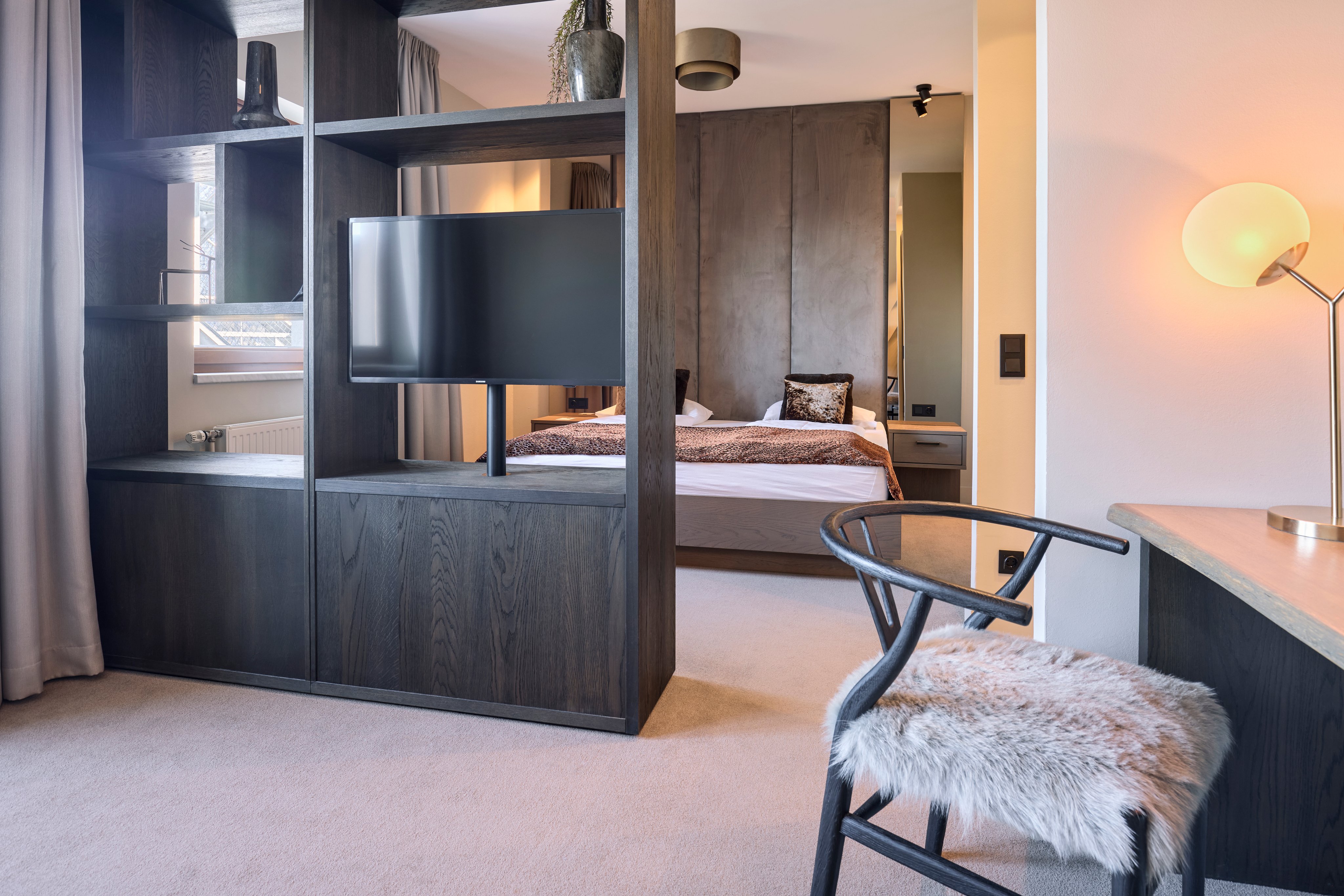 Moderner Hotelzimmerbereich bei Aldiana mit Bett, TV und Arbeitsbereich, komfortabel und elegant.