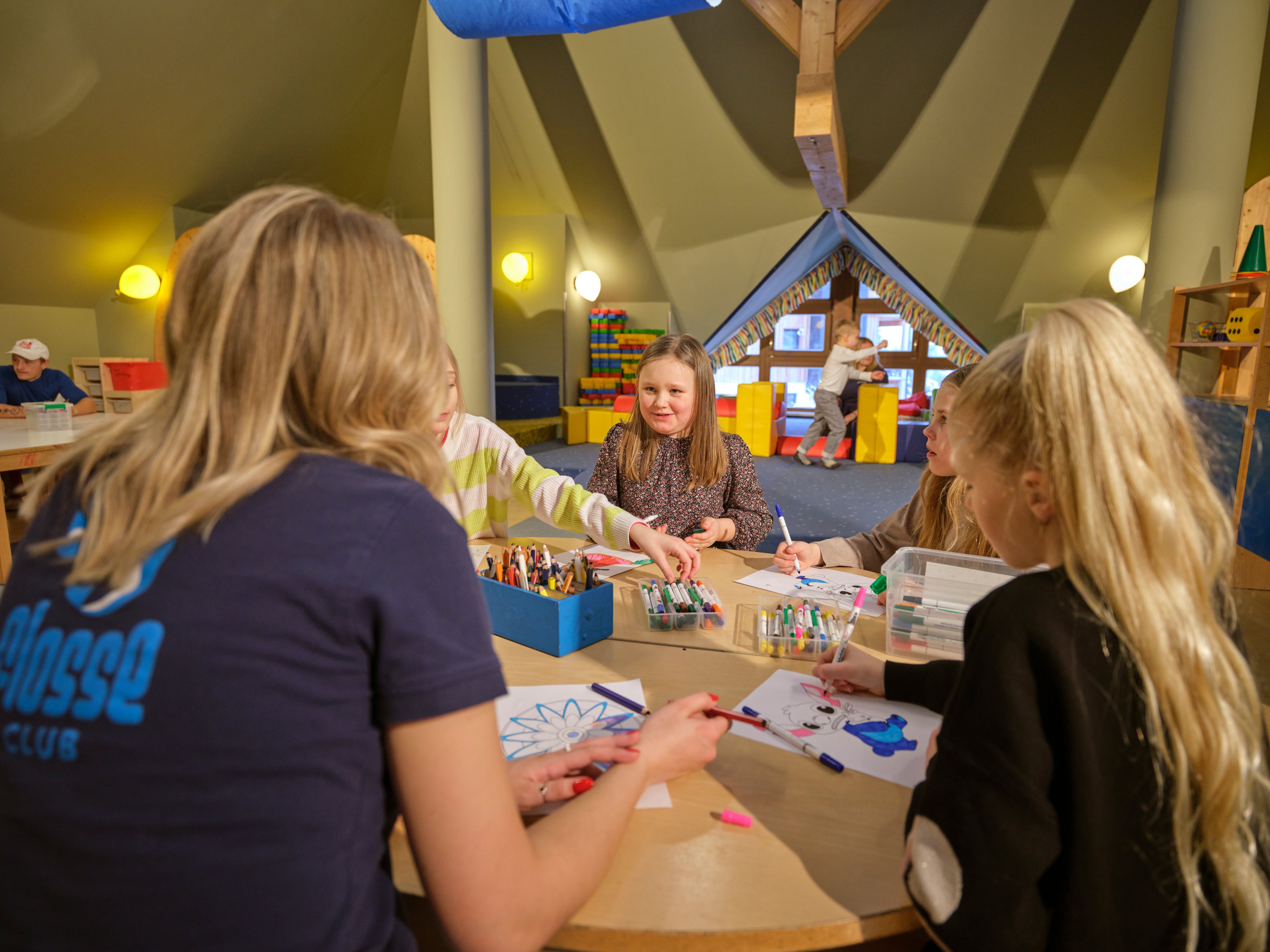 Kinder malen kreativ im bunten Aldiana Clubraum, ein Ort für exklusiven Familienurlaub