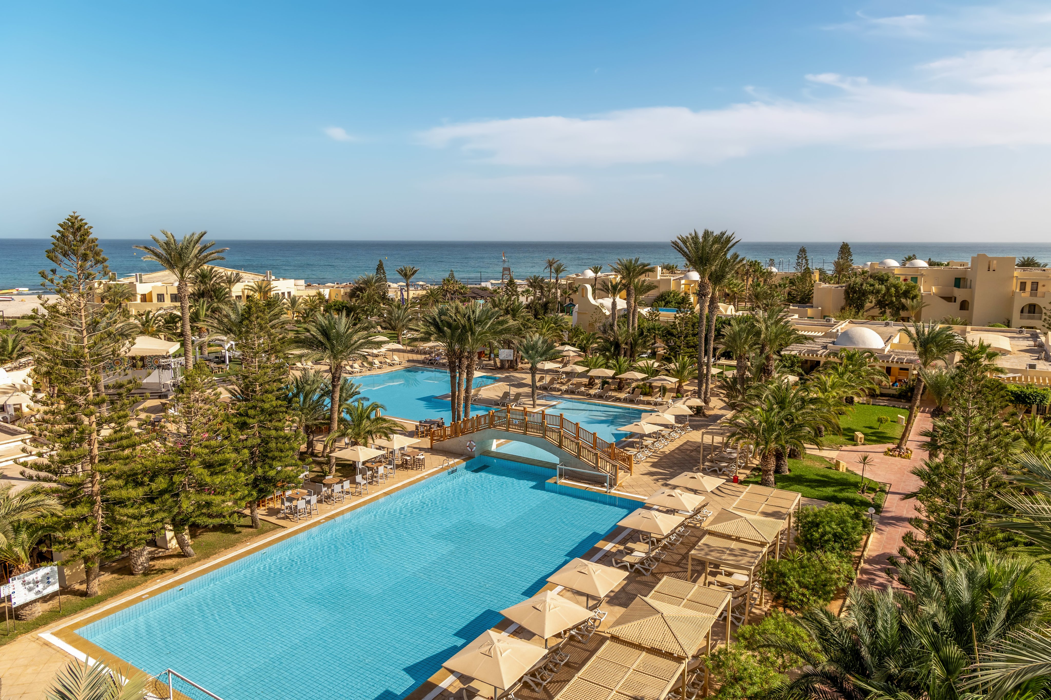 Blick auf den luxuriösen Poolbereich beim Premium Cluburlaub von Aldiana mit Palmen