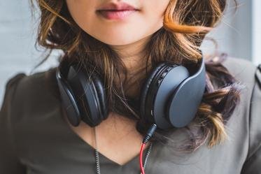 Gril with headphones around neck - Burst