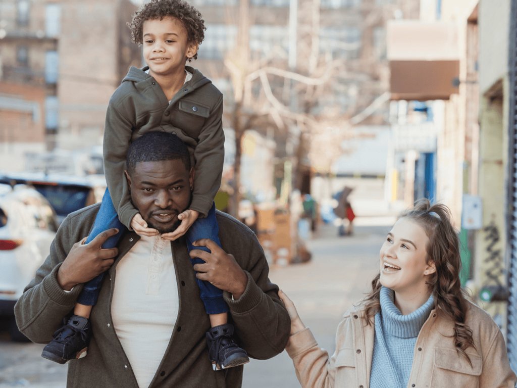 family-walking-child-on-dads-shoulders