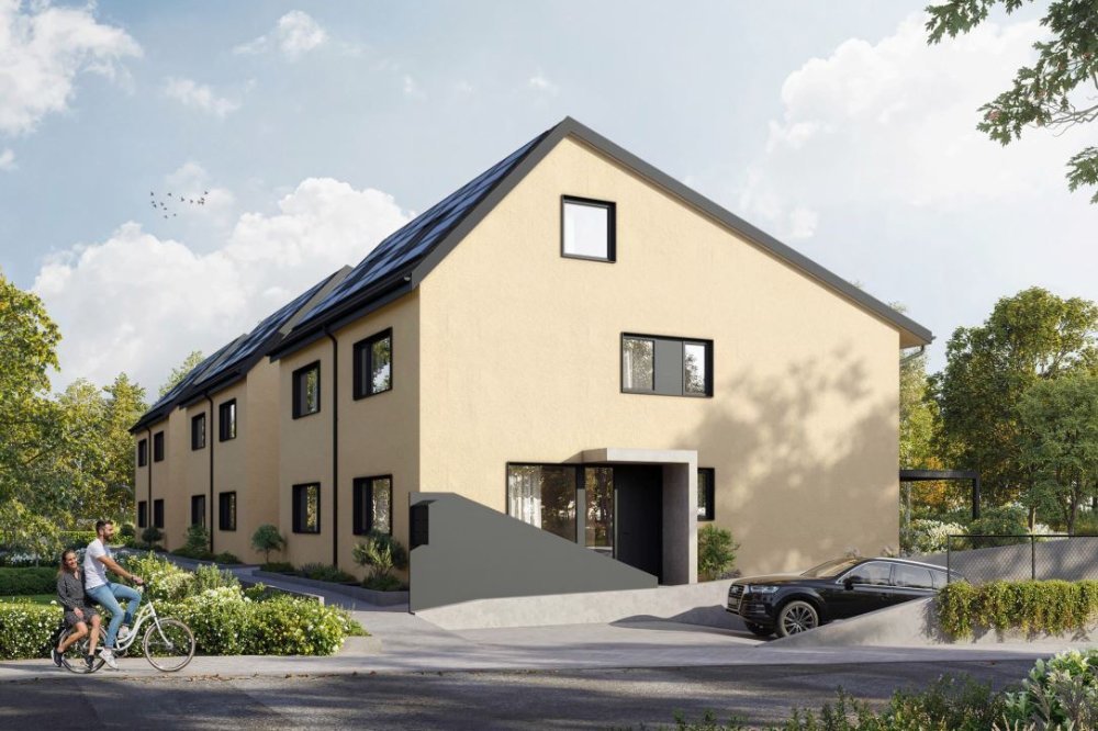 Gelbe Einfamilienhäuser mit Eingang und Garage am Baumgartenweg 57, 4132 Muttenz.