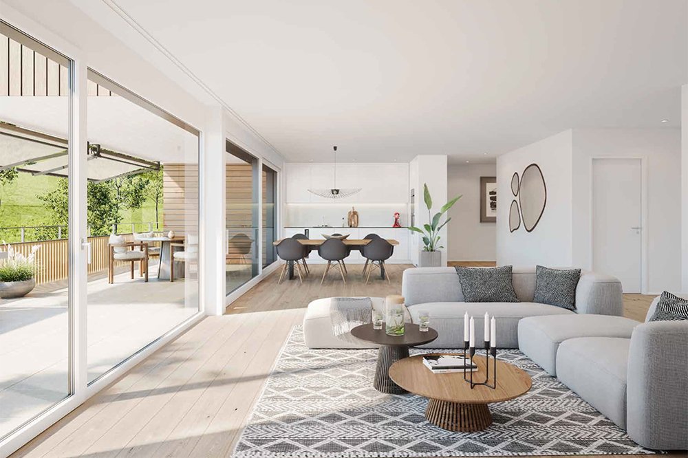 Ein heller, moderner Wohnraum mit Sofa, Couchtisch, Essbereich und grossem Fenster am Mettlenmatt, 4435 Niederdorf.