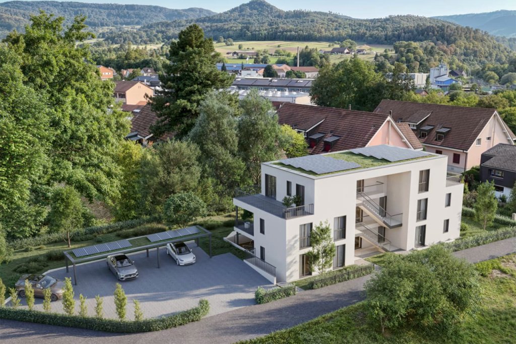 Modernes Mehrfamilienhaus mit Eigentumswohnungen, Grünflächen und Parkplätzen in einer ruhigen Umgebung an der Breitenbachstrasse 40, 4242 Laufen.