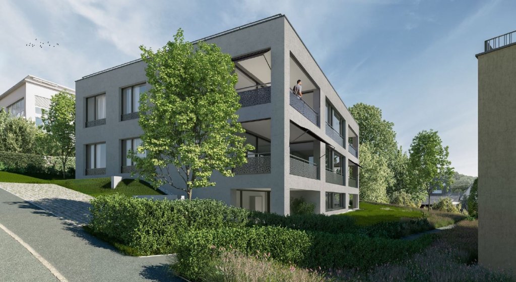 Moderne mehrstöckige Wohnanlage mit Bäumen und Grünflächen vor hellem Gebäude.