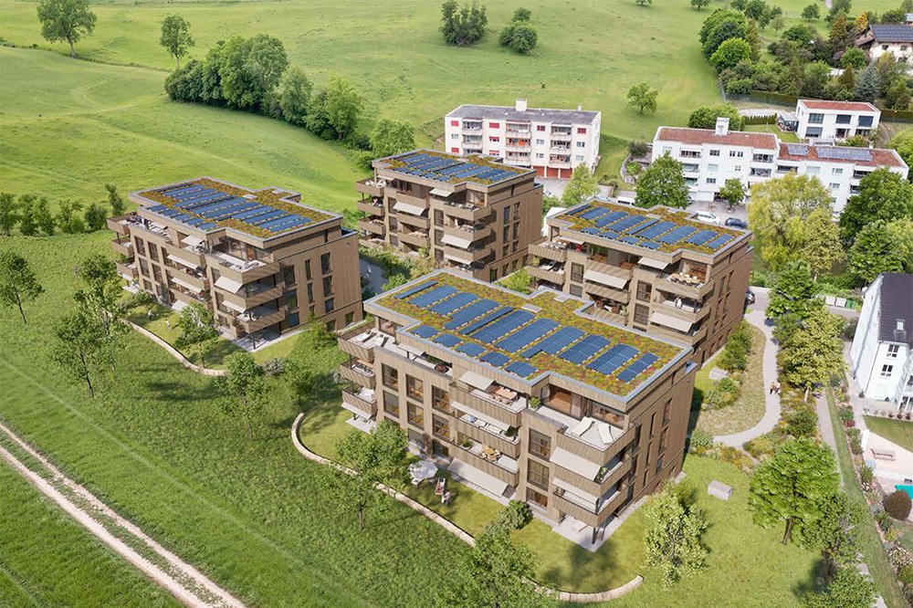 Mehrere moderne Gebäuden mit Solaranlagen auf dem Dach, umgeben von grünem Rasen und Bäumen am Mettlenmatt, 4435 Niederdorf.