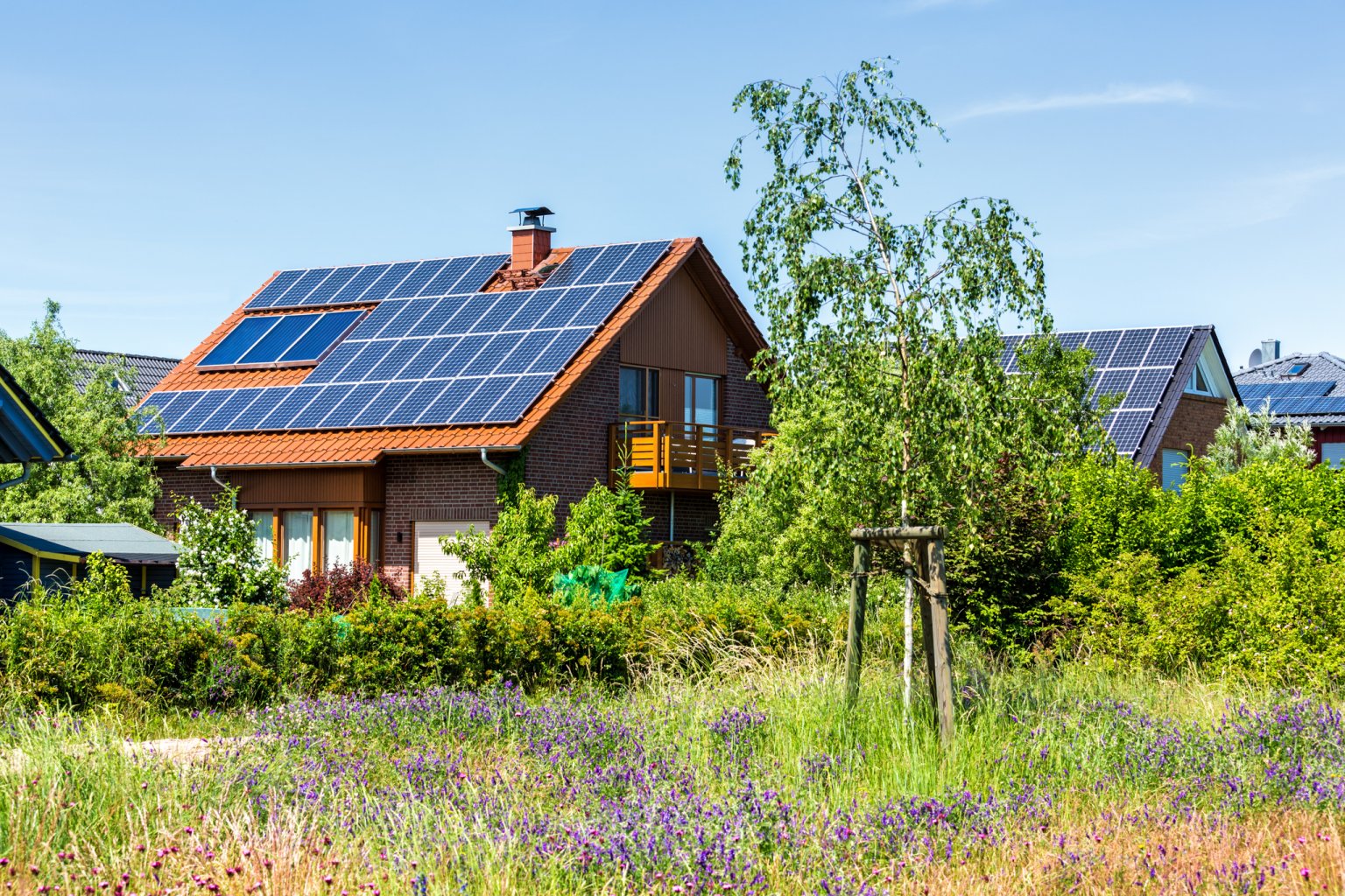 Energieeffizientes Einfamilienhaus mit Solarzellen und naturnaher Gartenanlage. aus dem Artikel Wie kann nachhaltiges Renovieren den Wert von Immobilien steigern?