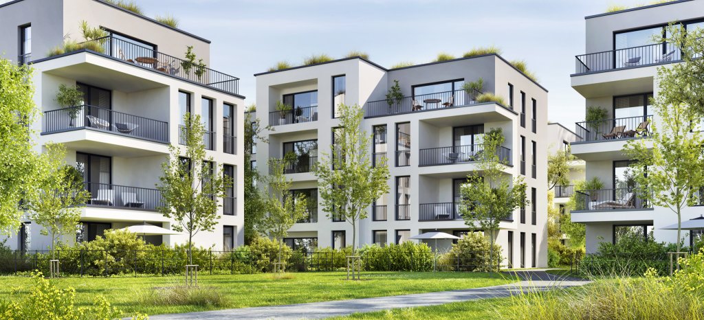 Moderne Wohnanlagen mit begrünten Balkonen in einer naturnahen Umgebung.