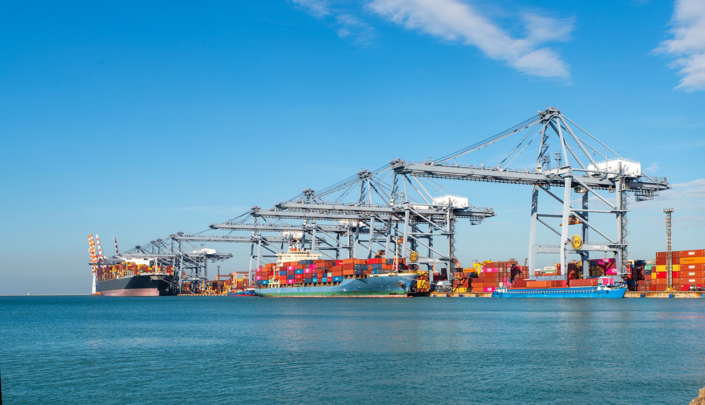 Image for Standards Partnership programme, to be used across marketing communications including event materials, social media, website etc. Container ship loading and unloading in sea port, aerial view of business logistic import and export freight transportation by container ship in harbor, container loading Cargo freight ship.