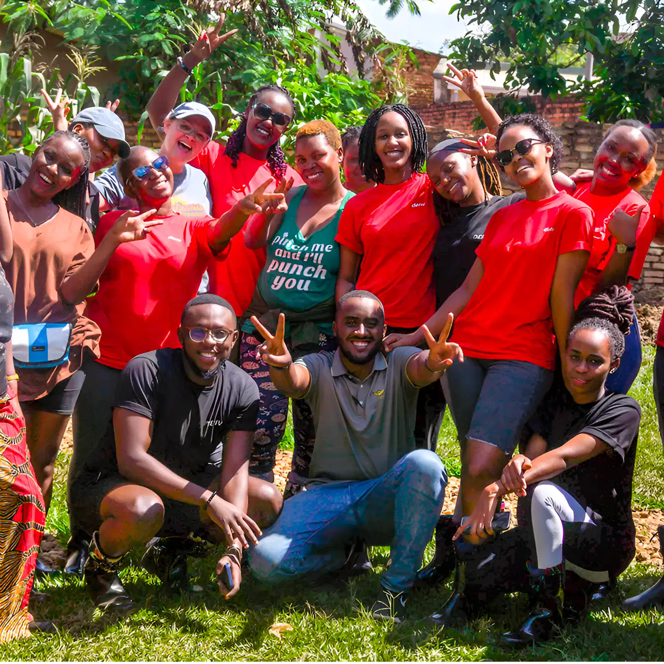 Deriv team members and community partners smile and pose together, reflecting unity and shared purpose behind the CSR vision.