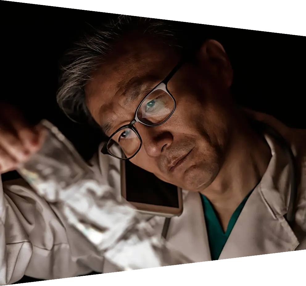 Middle aged doctor talking on smartphone looking at medicine