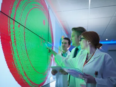 Scientists studying graphical display of silicon wafer on screens