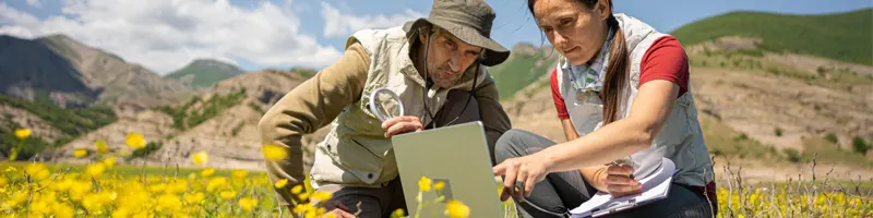 Ecologists working in the field using AI-driven application powered by solar energy