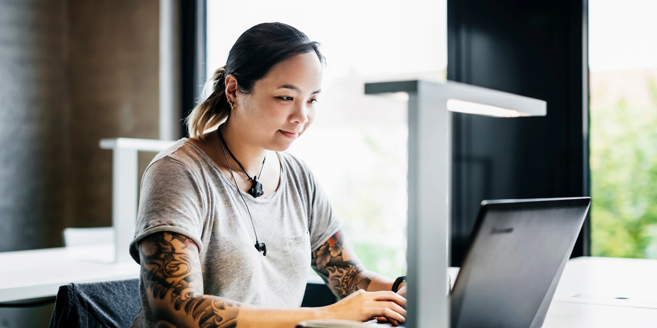 Young Woman Working On Laptop In Public Library