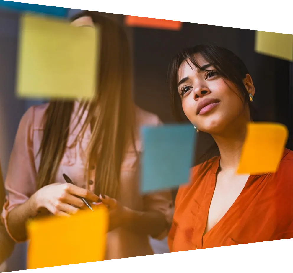Young businessman adding brainstorming ideas to a board