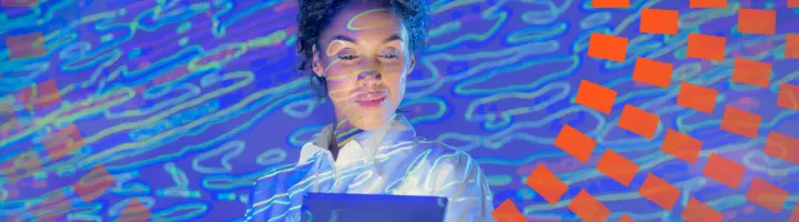 A woman in a blue background happy with her discovery