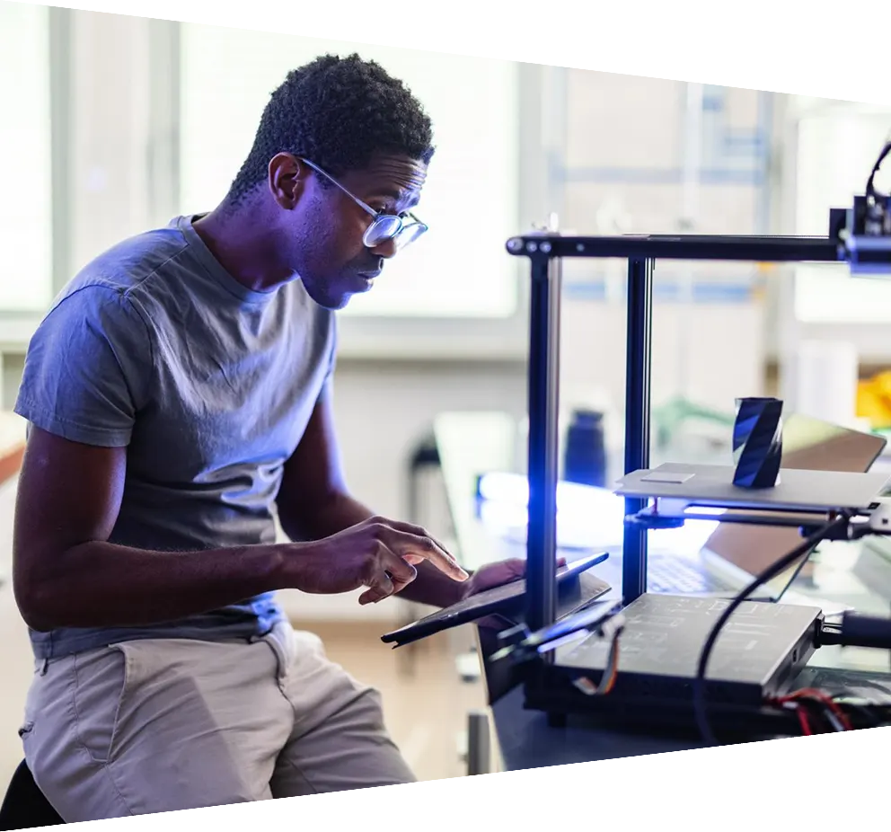 African-American Engineer Working On A 3D Printer