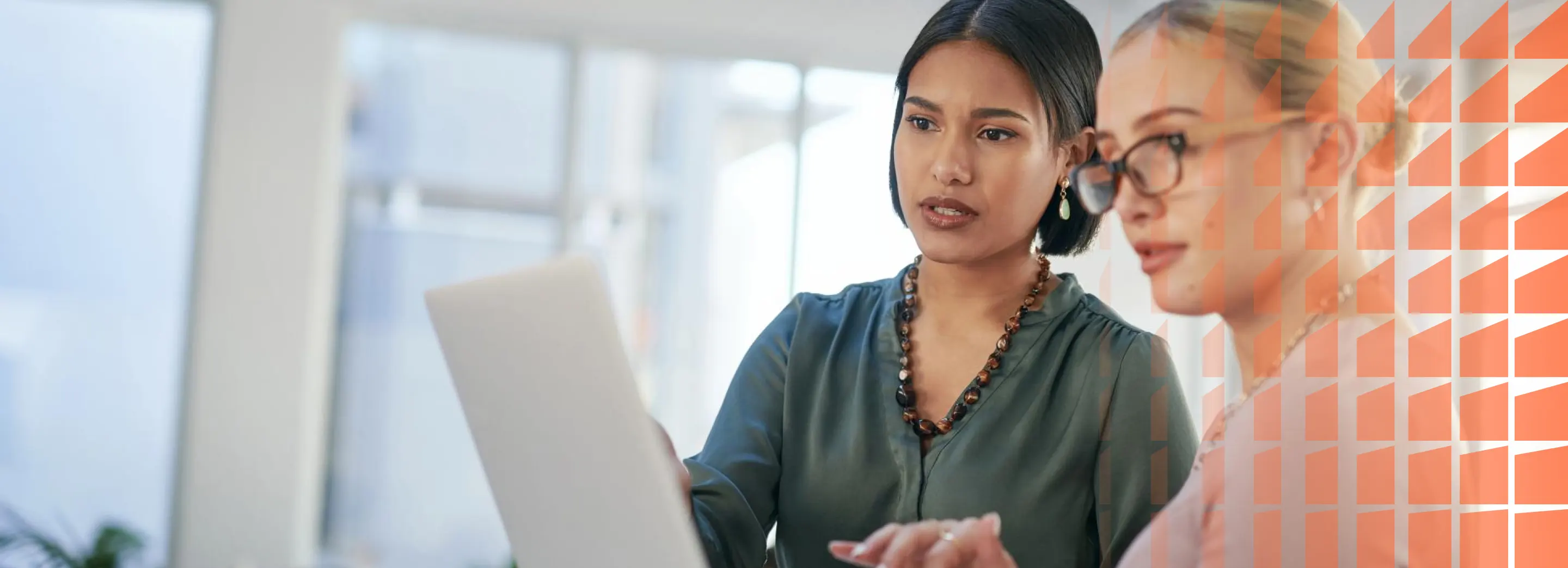Two women looking at a laptop