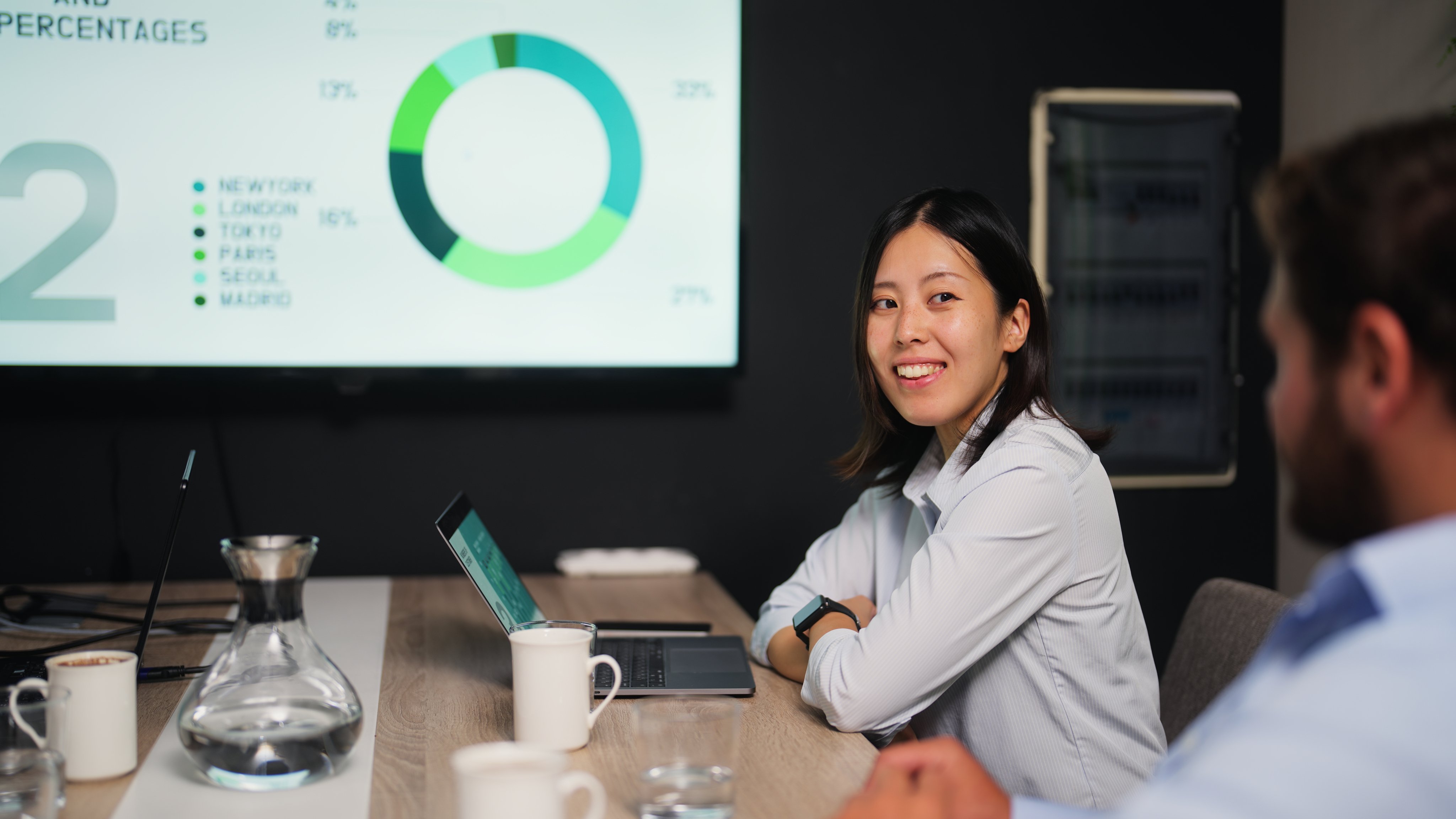 Young businesswoman attending business meeting in meeting room in modern office working space