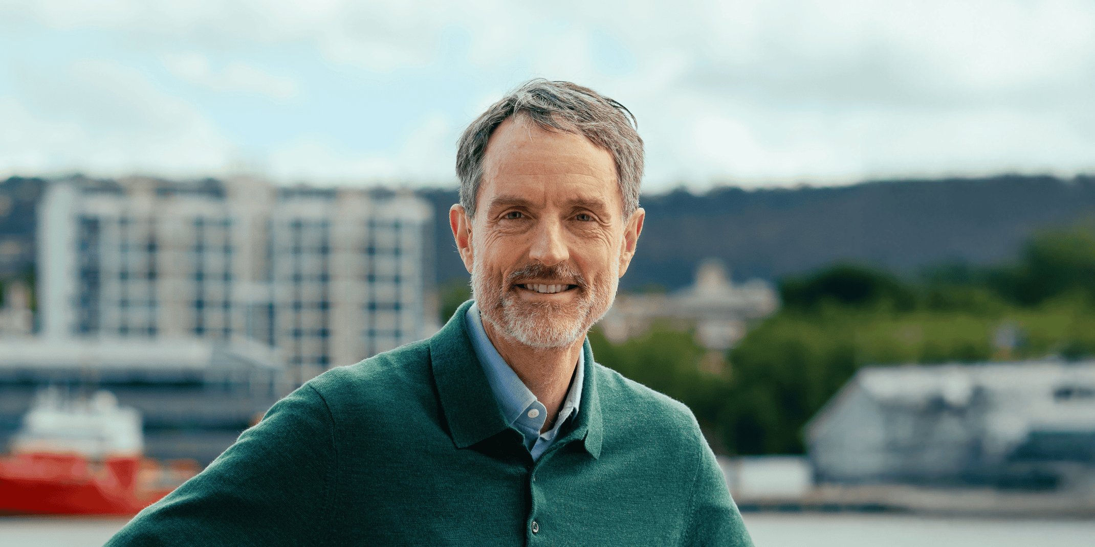 Photo of Prof Rufus Black, President and Vice-Chancellor of the University of Tasmania, on a decorative background